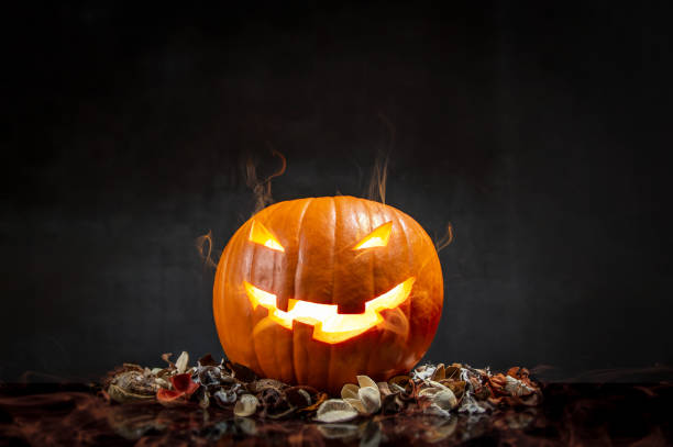 istock Composition of pumpkin on black background with glowing smoke. Horizontal orientation 1047166990