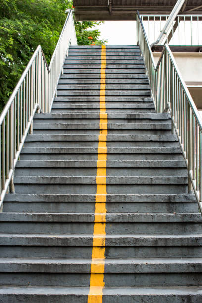 istock looking up to aged concrete staircase.Old stone stairs. 1047173092