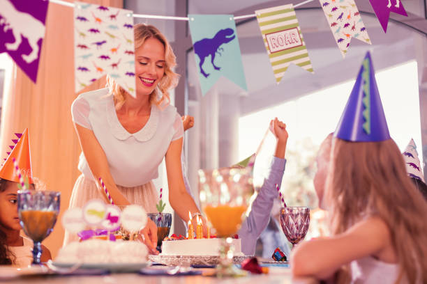 istock Kind mother smiling and putting big cake on the table 1047182968