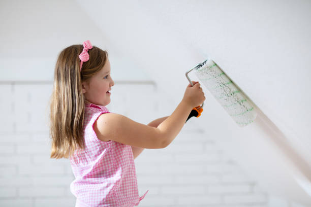 istock Kids painting attic wall. Home improvement. 1047183166