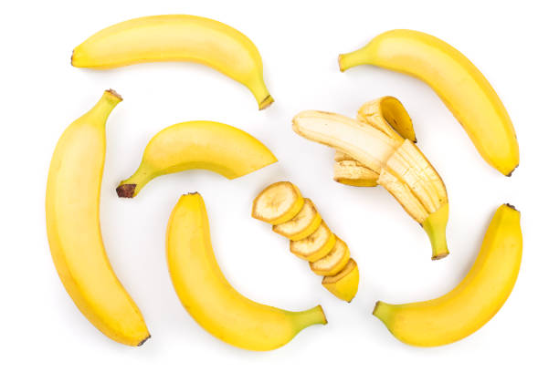 istock whole and sliced bananas isolated on white background. Top view. Flat lay 1047183498