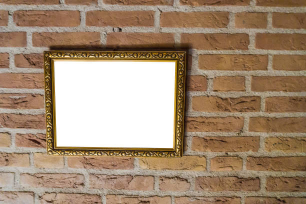istock empty golden vintage painting frame hanging on a brick wall background 1047183590
