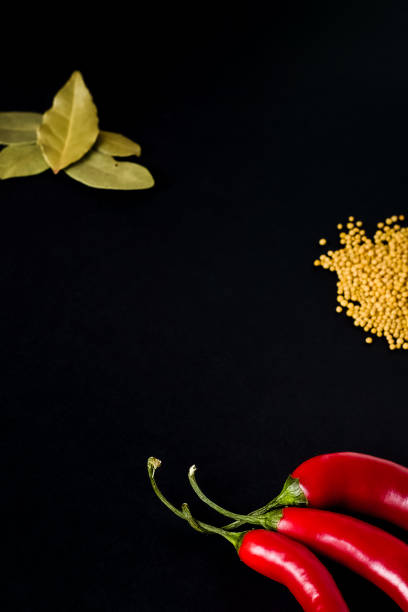 colored chili peppers on a wooden surface