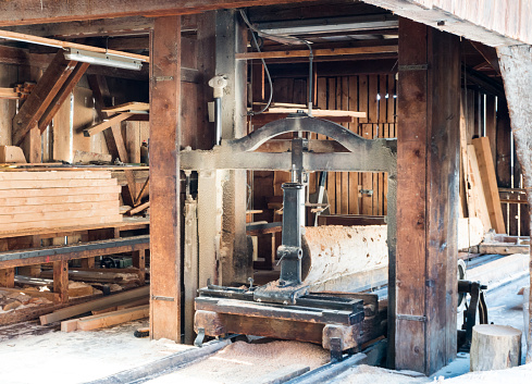 A view of the interior of an old traditional saw mill with old machines and tools