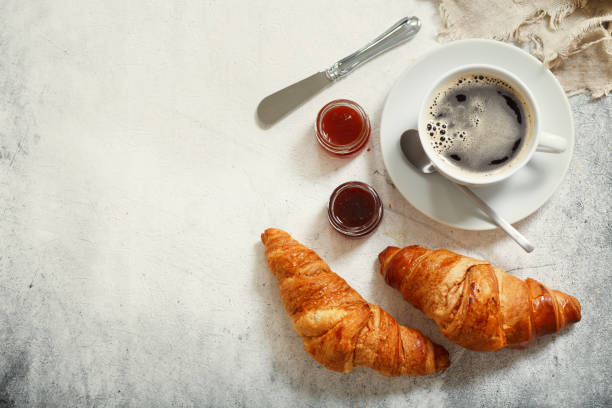 istock cup of coffee and croissants, top view 1047189880