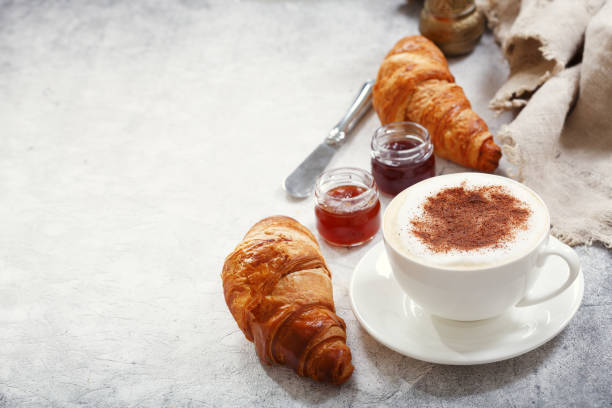 istock Cup of cappuccino coffee with croissants 1047189922
