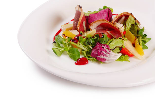 Salad with smoked duck breast close up