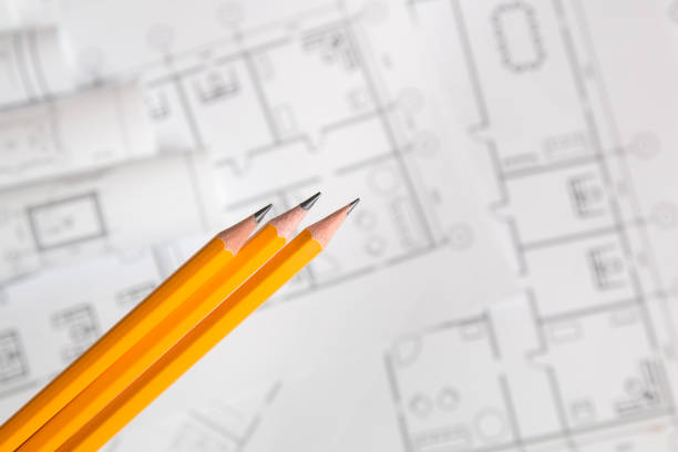 istock yellow pencil on architectural blueprint background 1047196578