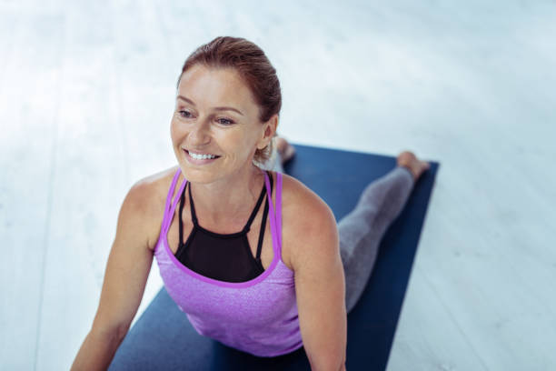 istock Beautiful mature woman maintaining balanced yoga pose 1047196652