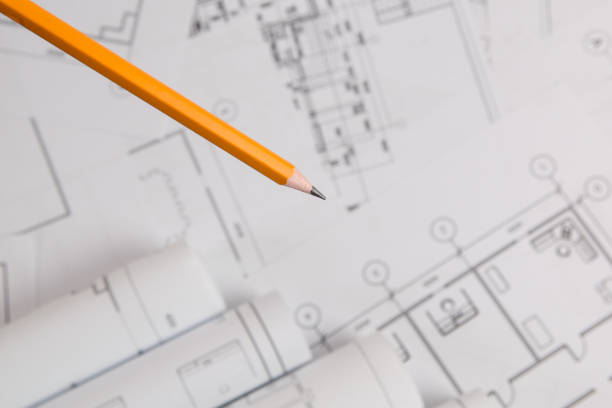 istock yellow pencil on architectural blueprint background 1047196950