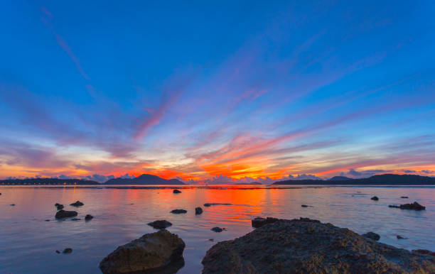 istock reflection of beautiful sunrise in Rawai sea 1047196968