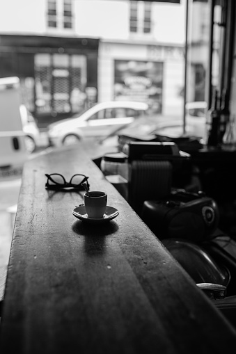 A coffee and glasses at the table while i was at a bar