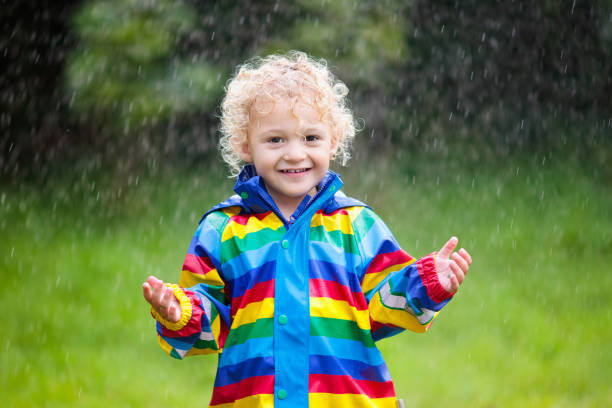 istock Little boy playing in the rain 1047207418