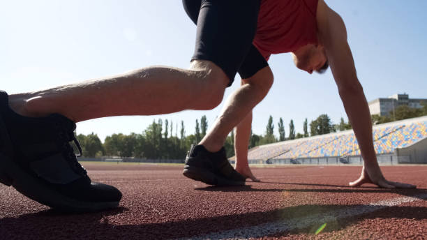 istock Sportsman beginning race with low start, professional trainings for victory 1047207944