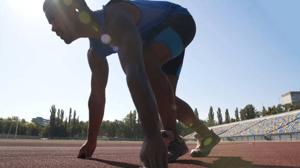istock Hispanic athlete in starting position ready to run, training to improve result 1047207970