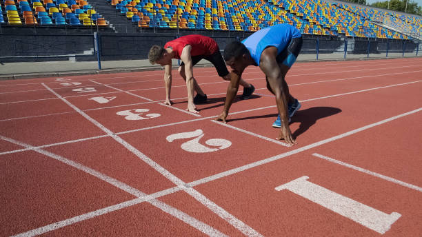 istock Multiracial athletes in starting position, ready to run after command, marathon 1047208118