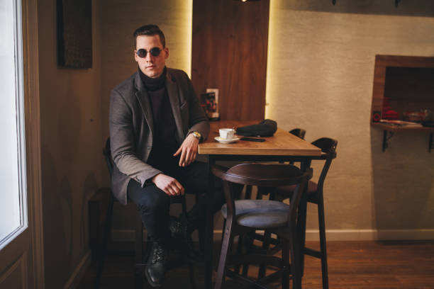istock Serious man having a coffee break at a cafe alone 1047213878