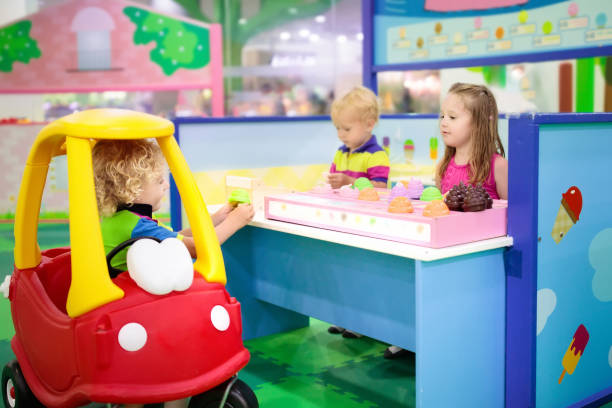 Kids play at toy supermarket or grocery store. Child playing in toy shop or restaurant. Educational toys and role game for kids. Kindergarten or preschool play room. Toddler kid at day care playground. Grocery store or supermarket for children. fruit cart vendor stock pictures, royalty-free photos & images