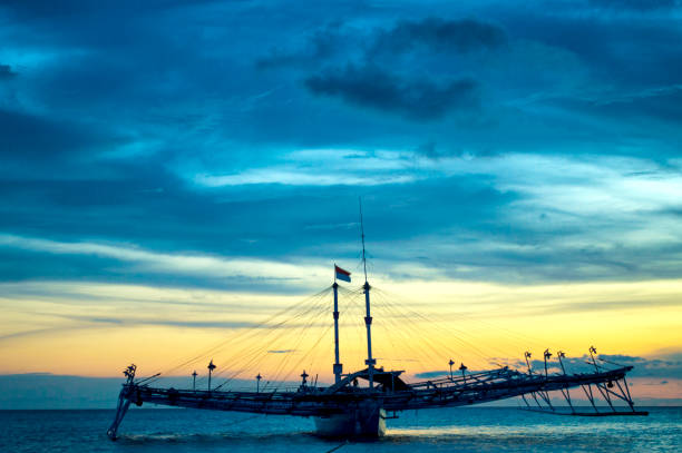 istock Sunset with boat views on the beach 1047216390