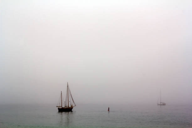 istock Sailing ship and paddle surfer in a misty day 1047217148