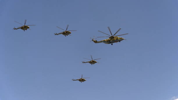 istock Combat helicopters Mi-26 and Mi-8 fly in sky 1047222934