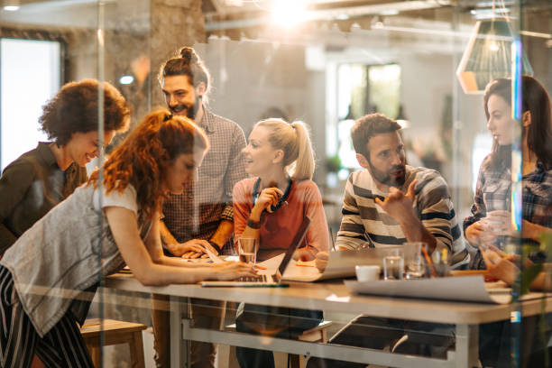 istock Large group of happy multi-tasking freelance workers at casual office. 1047223604