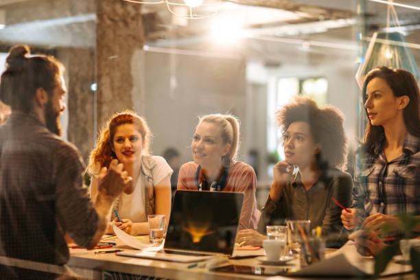 istock Happy freelance workers communicating on a casual meeting in the office. 1047226038