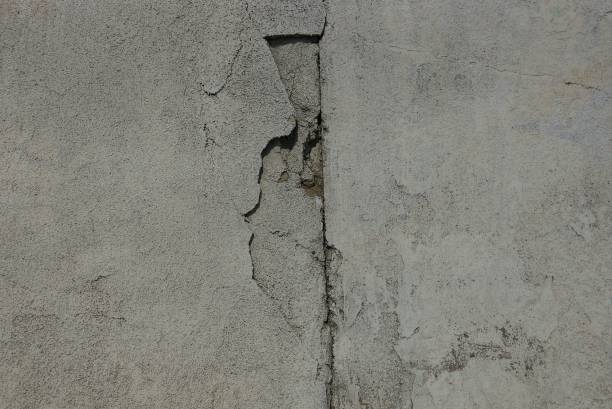 istock gray stone background from a dirty concrete wall with a crack 1047229470
