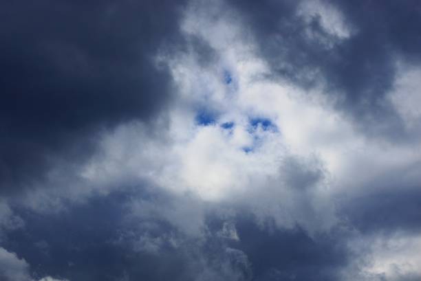 dark gray and white big clouds and blue sky