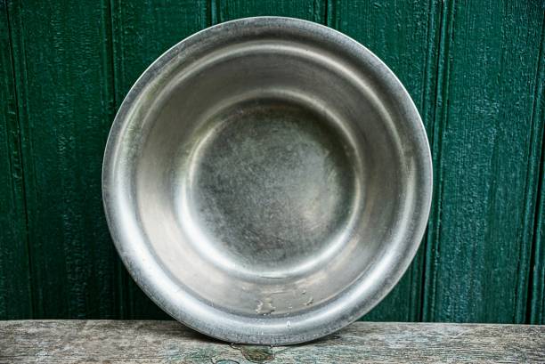 istock one large gray metal bowl on a table against a green wall 1047229736