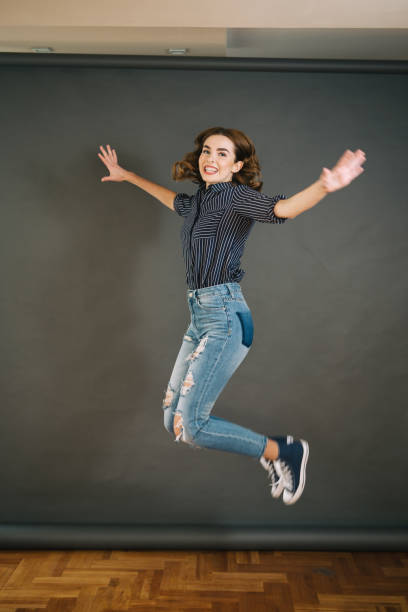 istock Cheerful jumping girl in mid-air 1047233012