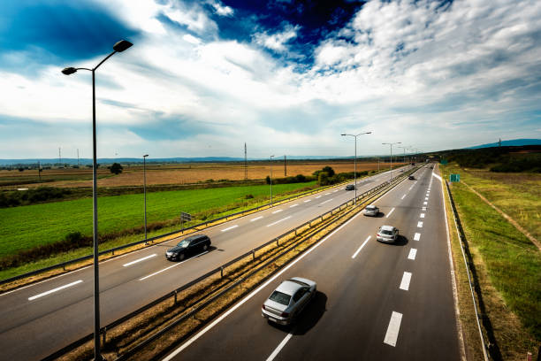 istock Highway Traffic on a straight road on a Cloudy Day 1047233118