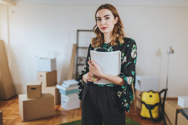 istock Gorgeous real estate agent in a boxed apartment 1047238378