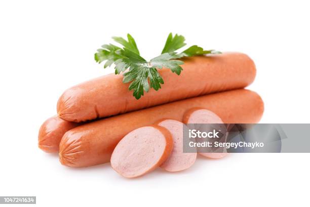 Three Sausages With Slices And Fresh Parsley Isolated On White Background Stock Photo - Download Image Now