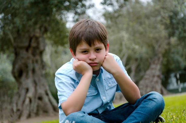 istock Toddler boy with funny face sad or bored 1047242144