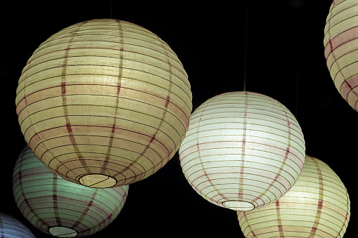 Suspended spherical lamps luminous in the darkness of the night