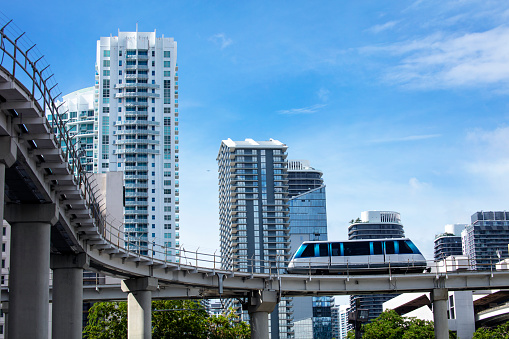 Miami downtown Cityscape with Metromover behind Business Buildings and Blue Sky