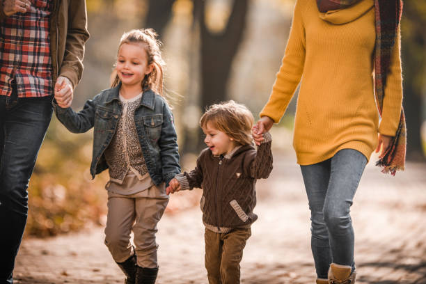 istock Happy kids having fun with their unrecognizable parents in nature. 1047256922
