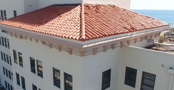 The building was hit by a strong hail storm and ruined the roof shingles very much.