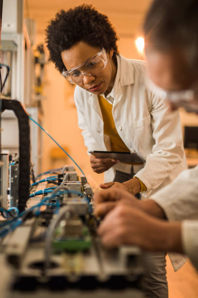 istock African American engineer cooperating with her colleague in laboratory. 1047267354