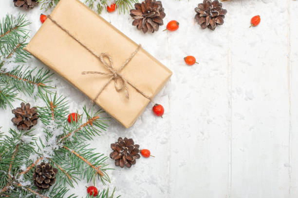istock Christmas background with decorations and gift boxes on a white wooden board 1047275190