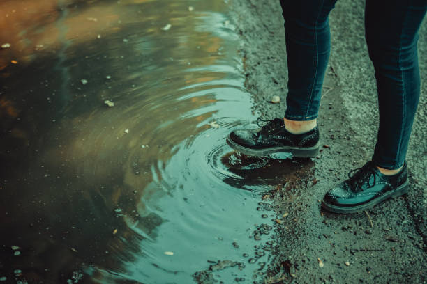istock Woman walking outdoor after a rainfall 1047282568