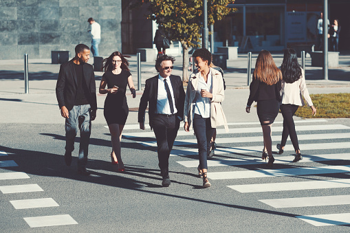 Business people crossing the city street.