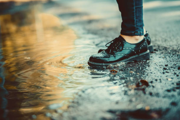 istock Woman walking outdoor after a rainfall 1047282862