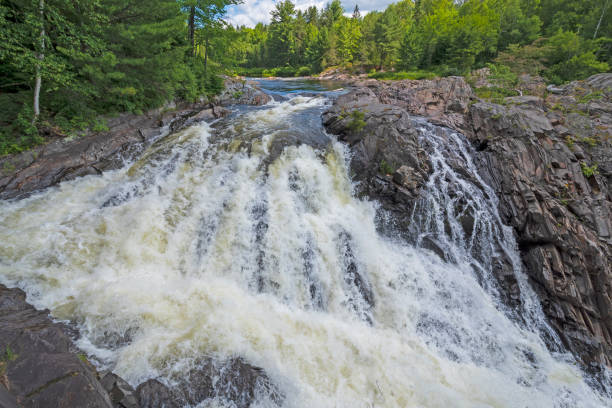 istock Roaring Falls over a Rocky Outcrop 1047283178