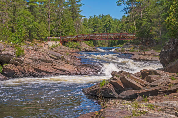 istock Footbridge over a Wilderness River 1047283188
