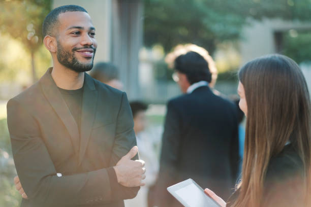 istock Business persons talking in the park 1047285410