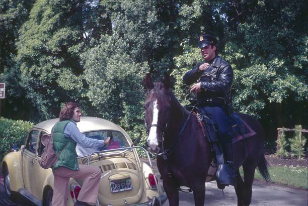 San Francisco, California, 1977. A police officer on horseback issues a parking ticket for incorrect parking.