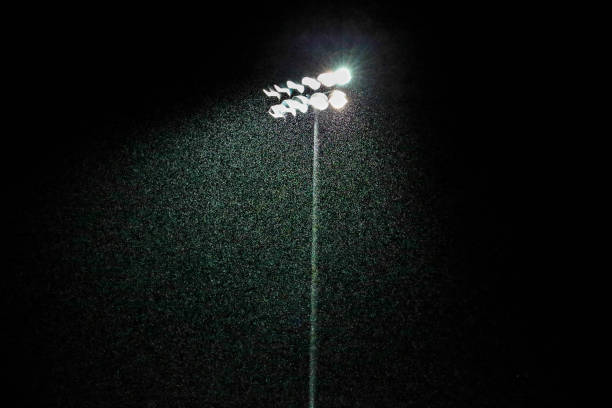 High school stadium lights during the rain stock photo