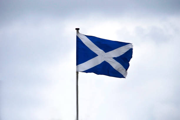 Flag of Scotland on the blue sky background stock photo